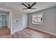 Bright bedroom features wood-look flooring, ceiling fan, closet, and window providing natural light at 12119 Buffington Ln, Riverview, FL 33579
