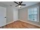 Cozy bedroom featuring a window, closet, and stylish wood-look flooring at 12119 Buffington Ln, Riverview, FL 33579