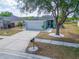 Lovely home with a well-manicured lawn, a mature tree, and a long driveway at 12119 Buffington Ln, Riverview, FL 33579