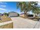 Inviting single-story home with a two-car garage, mature trees and landscaping at 12119 Buffington Ln, Riverview, FL 33579