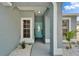 Cozy front porch featuring white rock landscaping and a decorative blue front door with glass window at 12119 Buffington Ln, Riverview, FL 33579