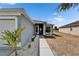 Inviting covered front porch with decorative landscaping and a brightly painted front door at 12119 Buffington Ln, Riverview, FL 33579