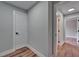 Neutral hallway with white doors and wood-look floors, leading to other rooms at 12119 Buffington Ln, Riverview, FL 33579
