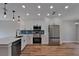 Bright kitchen with stainless appliances, sleek countertops, and modern fixtures at 12119 Buffington Ln, Riverview, FL 33579