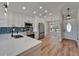 Well-lit kitchen with stainless appliances, white cabinets, and stylish backsplash at 12119 Buffington Ln, Riverview, FL 33579
