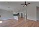 Living room boasts modern lighting, a ceiling fan, and sleek hardwood floors at 12119 Buffington Ln, Riverview, FL 33579