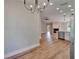 Open-concept living room showcasing the kitchen, stone fireplace, and wood flooring at 12119 Buffington Ln, Riverview, FL 33579