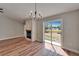 Open-concept room featuring a fireplace, modern lighting, and wood flooring at 12119 Buffington Ln, Riverview, FL 33579
