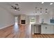 Open-concept kitchen and living space with modern light fixtures, stainless appliances, and fireplace at 12119 Buffington Ln, Riverview, FL 33579
