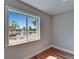 A serene view through the window overlooking a tranquil pond surrounded by lush palm trees and clear blue skies at 12119 Buffington Ln, Riverview, FL 33579