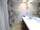 Well-lit bathroom featuring a shower/tub combo and large vanity with ample countertop space at 124 Woodlake Wynde, Oldsmar, FL 34677