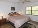 Cozy bedroom with a comfortable bed, a nightstand, and a bright window at 124 Woodlake Wynde, Oldsmar, FL 34677