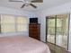 Bedroom with dresser, window with blinds, and sliding doors to balcony at 124 Woodlake Wynde, Oldsmar, FL 34677