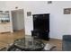 Living area features a wet bar, a modern TV stand, and a glass coffee table with views into other rooms at 124 Woodlake Wynde, Oldsmar, FL 34677