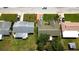 Overhead shot of the property, highlighting the roof, driveway, and proximity to other houses in the neighborhood at 12407 Partridge Hill Row, Hudson, FL 34667