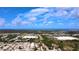 Expansive aerial view of the community, showcasing its layout, nearby commercial areas, and ocean in the distance at 12407 Partridge Hill Row, Hudson, FL 34667