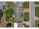 Aerial view of the property showing the roof, surrounding landscape, and proximity to neighboring houses at 12407 Partridge Hill Row, Hudson, FL 34667