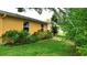Lush backyard featuring mature trees and green lawn, creating a tranquil retreat area at 12407 Partridge Hill Row, Hudson, FL 34667