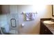Updated bathroom featuring a glass shower door and modern fixtures at 12407 Partridge Hill Row, Hudson, FL 34667
