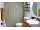 Bathroom with a shower, shelves, and a decorative mirror at 12407 Partridge Hill Row, Hudson, FL 34667