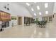 Spacious common room with a fireplace, vaulted ceilings, and large windows offering plenty of natural light at 12407 Partridge Hill Row, Hudson, FL 34667