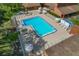 Aerial view of the community pool with lounge chairs and umbrellas offering a relaxing oasis at 12407 Partridge Hill Row, Hudson, FL 34667