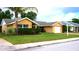 Charming single-story home with a lush green lawn, mature landscaping, and attached one car garage at 12407 Partridge Hill Row, Hudson, FL 34667