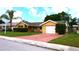 Charming single-story home featuring lush landscaping, a driveway, and a one-car garage at 12407 Partridge Hill Row, Hudson, FL 34667