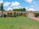 Charming single-story home featuring a well-maintained lawn and a two-car garage, enhancing curb appeal at 12407 Partridge Hill Row, Hudson, FL 34667
