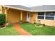 Inviting home featuring a garden pathway leading to the front door and a manicured lawn at 12407 Partridge Hill Row, Hudson, FL 34667