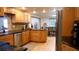 Well-equipped kitchen featuring stainless steel appliances, ample counter space, and a view into the dining area at 12407 Partridge Hill Row, Hudson, FL 34667