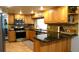Modern kitchen featuring granite countertops, stainless steel appliances, and custom wood cabinetry at 12407 Partridge Hill Row, Hudson, FL 34667