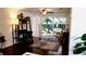 Cozy living room with a desk area and sliding glass doors that let in natural light and lead to the outdoors at 12407 Partridge Hill Row, Hudson, FL 34667