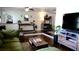 Bright living room with a comfortable green sofa, wood floors, and decorative accents at 12407 Partridge Hill Row, Hudson, FL 34667