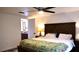 Cozy main bedroom with a ceiling fan and updated ensuite bathroom at 12407 Partridge Hill Row, Hudson, FL 34667