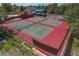 Aerial view of well-maintained tennis courts, perfect for active residents and friendly matches at 12407 Partridge Hill Row, Hudson, FL 34667