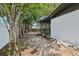 Home featuring a rear exterior with mature trees and a partial view of the screened-in porch at 1332 Marjohn Ave, Clearwater, FL 33756