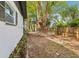 Home featuring a spacious backyard with a mix of mature trees and a wooden fence at 1332 Marjohn Ave, Clearwater, FL 33756
