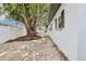 Home featuring a spacious brick patio with a white fence and mature trees offering ample shade at 1332 Marjohn Ave, Clearwater, FL 33756