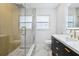 Updated bathroom with glass enclosed shower, rain shower head, modern vanity and LED mirror at 1332 Marjohn Ave, Clearwater, FL 33756