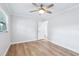 Bright bedroom with wood floors, a ceiling fan, and a door leading to another room at 1332 Marjohn Ave, Clearwater, FL 33756