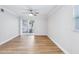 A bright bedroom featuring hardwood floors, a ceiling fan and access to outdoor views at 1332 Marjohn Ave, Clearwater, FL 33756