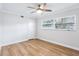 A well-lit bedroom with wood floors, a ceiling fan, and large windows providing natural light at 1332 Marjohn Ave, Clearwater, FL 33756