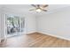 Bright bedroom featuring hardwood floors, a modern ceiling fan, and a sliding glass door to the outside at 1332 Marjohn Ave, Clearwater, FL 33756