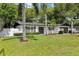 Charming home featuring a well-manicured lawn, fresh landscaping, and a white exterior with decorative shutters at 1332 Marjohn Ave, Clearwater, FL 33756