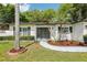 Well maintained property showcasing mature landscaping and a modern front door at 1332 Marjohn Ave, Clearwater, FL 33756