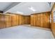 Roomy garage with wood-paneled walls, offering a versatile area for parking and storage at 1332 Marjohn Ave, Clearwater, FL 33756