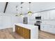 Bright, updated kitchen featuring stainless steel appliances, marble countertops, and modern pendant lighting at 1332 Marjohn Ave, Clearwater, FL 33756