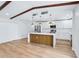 Well-lit kitchen features stainless steel appliances, a center island, and white cabinets and countertops at 1332 Marjohn Ave, Clearwater, FL 33756