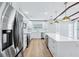 Open kitchen with marble countertops, stainless steel appliances, a wine cooler, and modern pendant lighting at 1332 Marjohn Ave, Clearwater, FL 33756